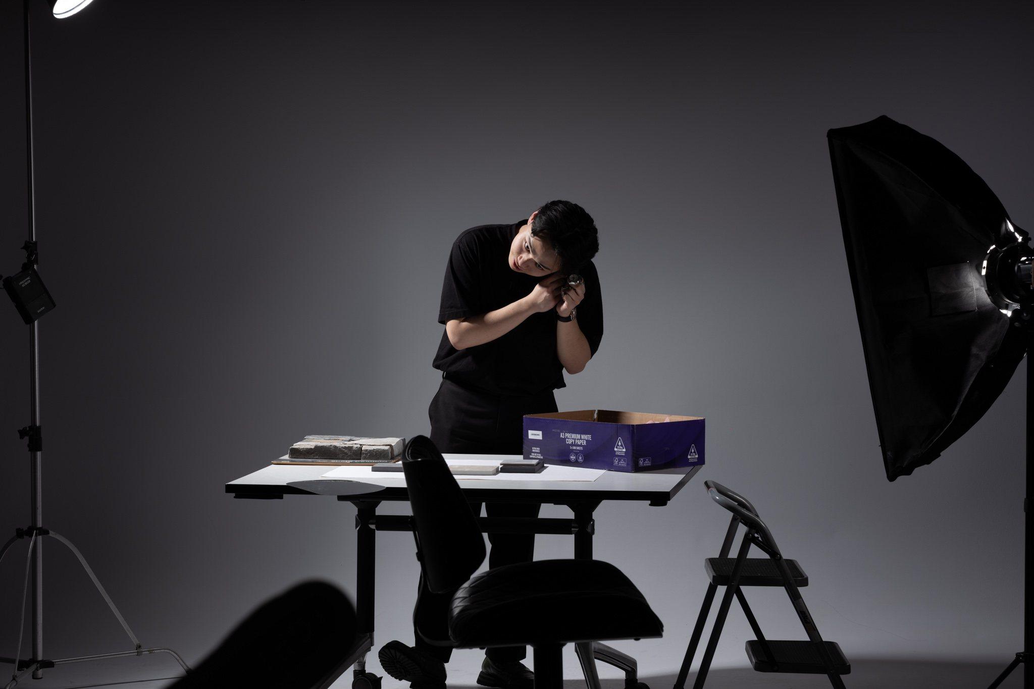 In the studio: fitting a strap under a softbox.